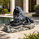 Black marble lion couchant on its rough grey rock base