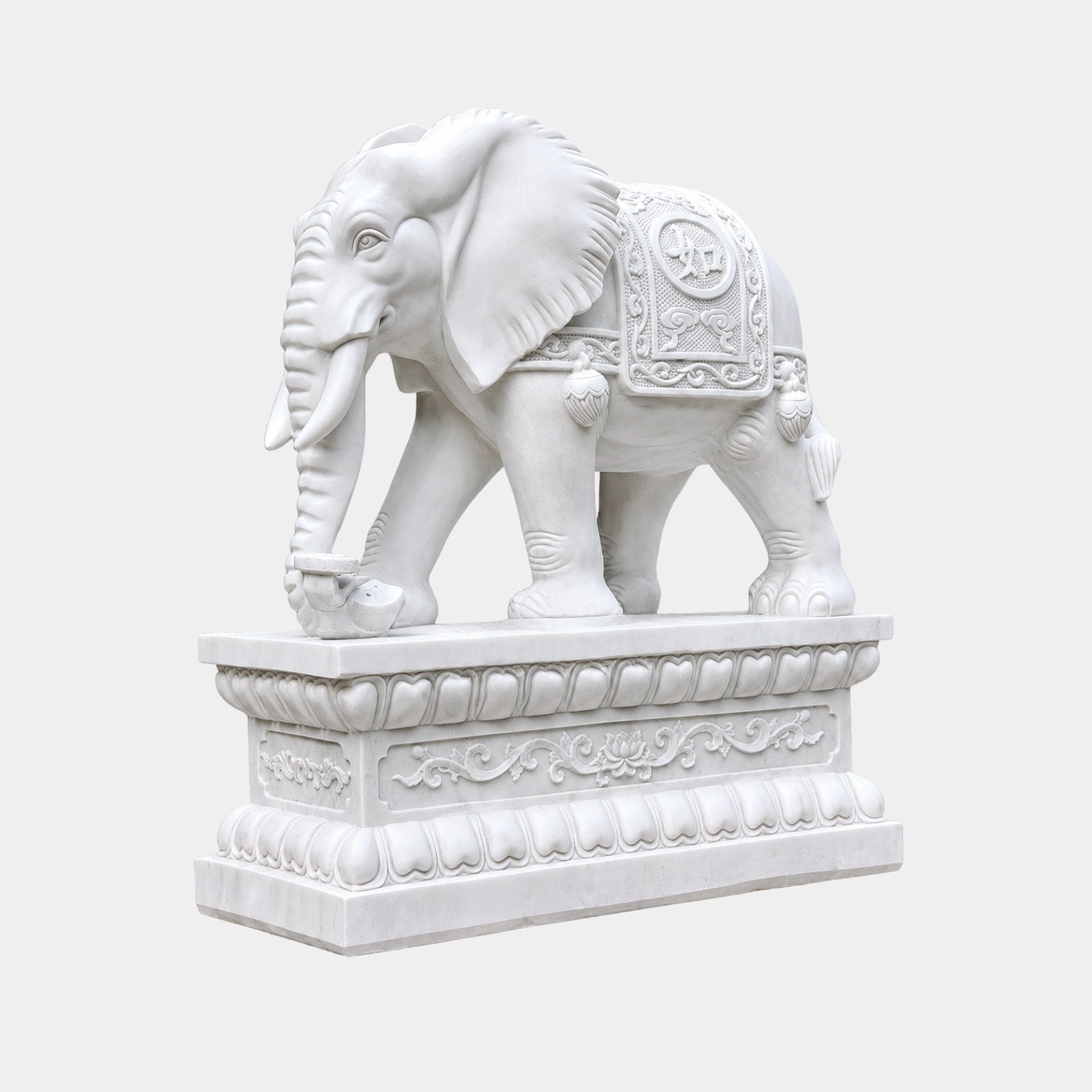 White marble elephant with a carved saddle-cloth roundel on a lotus pedestal