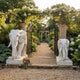White marble elephant, naturalistic and unadorned, trunk curling to the base