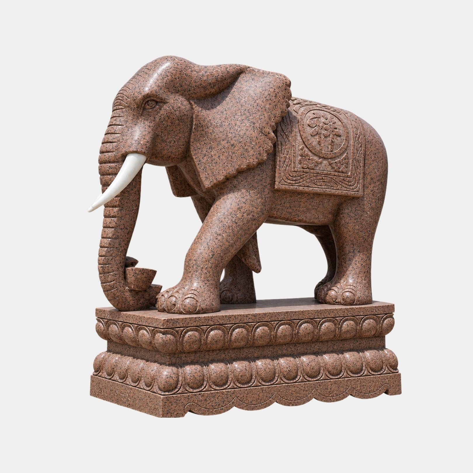 Red granite elephant with pale tusks on a lotus-banded pedestal