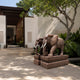 Red granite elephant with white tusks and a carved saddle-cloth