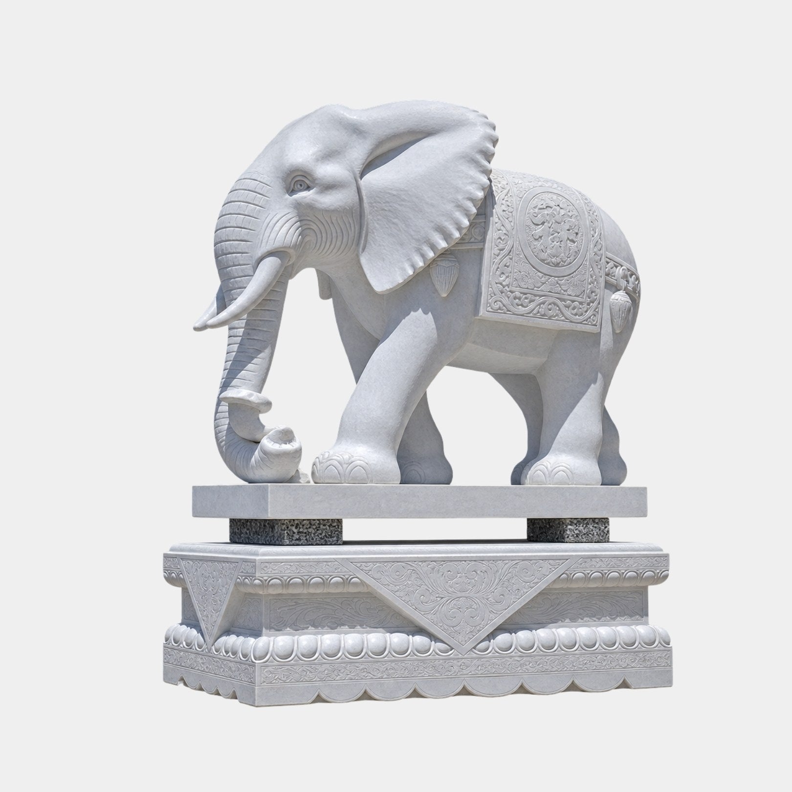 White marble caparisoned elephant on a slab and a moulded lotus pedestal