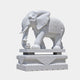 White marble caparisoned elephant on a slab and a moulded lotus pedestal