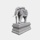 Grey granite elephant with pale tusks and a carved mask cloth