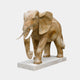 Olive-tan marble elephant standing unadorned with pale tusks