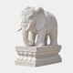 White marble elephant with a rosette headpiece and beaded harness