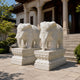 White marble elephant with a rosette headpiece and beaded chest chain