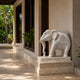 White marble elephant with a carved headpiece and a floral roundel cloth