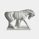 White marble horse with head lowered, wearing a bridle and girthed saddle