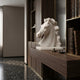 The marble horse head on a walnut shelf in a panelled library