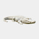White marble crocodile lying at full stretch with raised scutes along its back