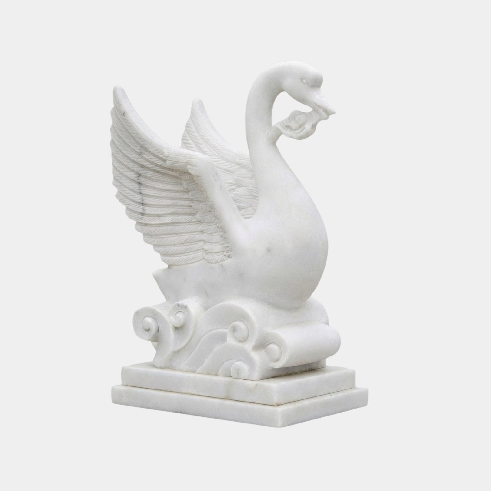 White marble swan with wings raised and a carved scroll held in its bill