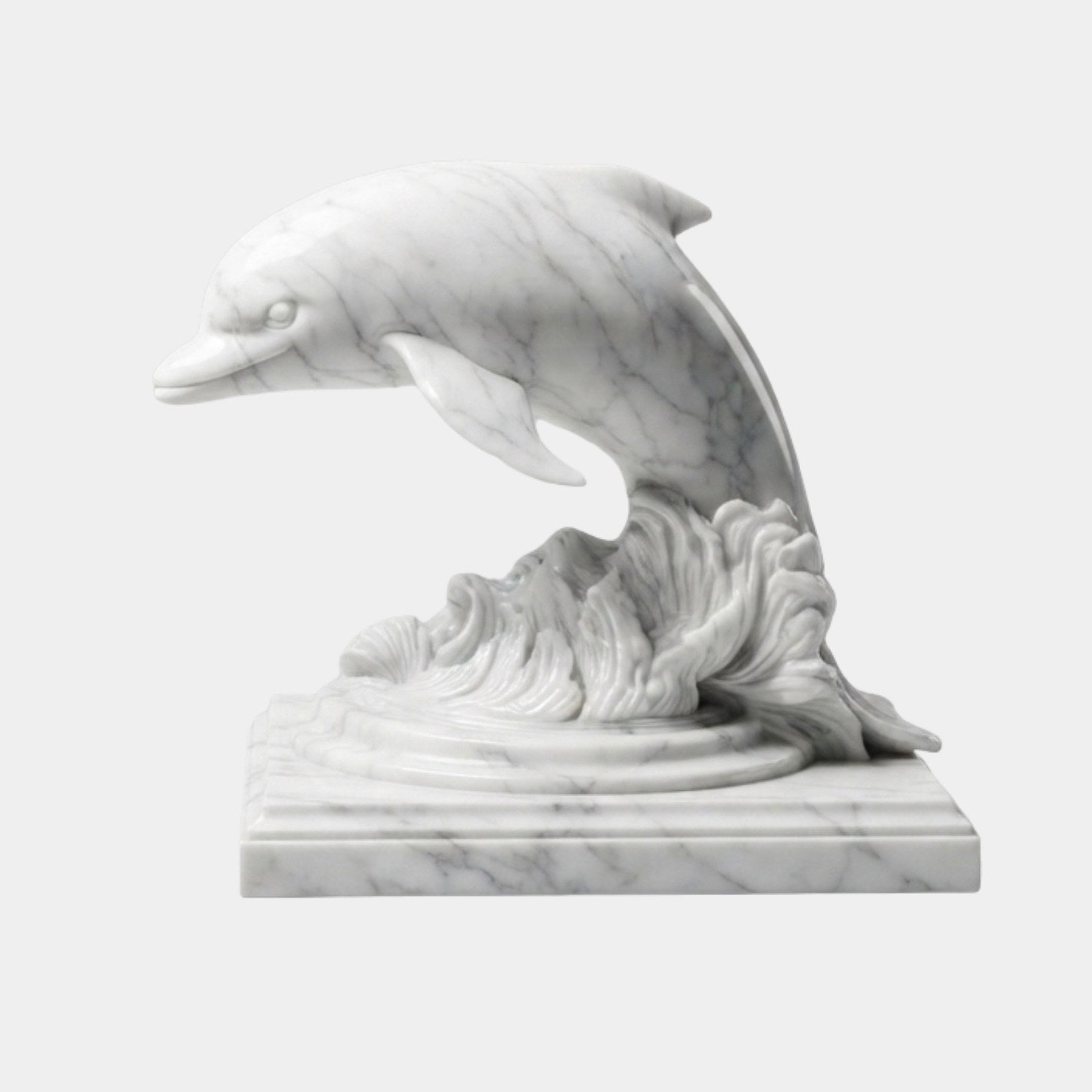 White marble dolphin arched clear of a carved breaking wave