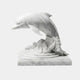 White marble dolphin arched clear of a carved breaking wave