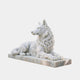 White marble wolf lying couchant with a heavy carved ruff and erect ears