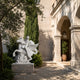 White marble rider and winged horse shown in a gravelled courtyard