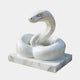 White marble snake resting coiled with its head and neck raised in an S-curve
