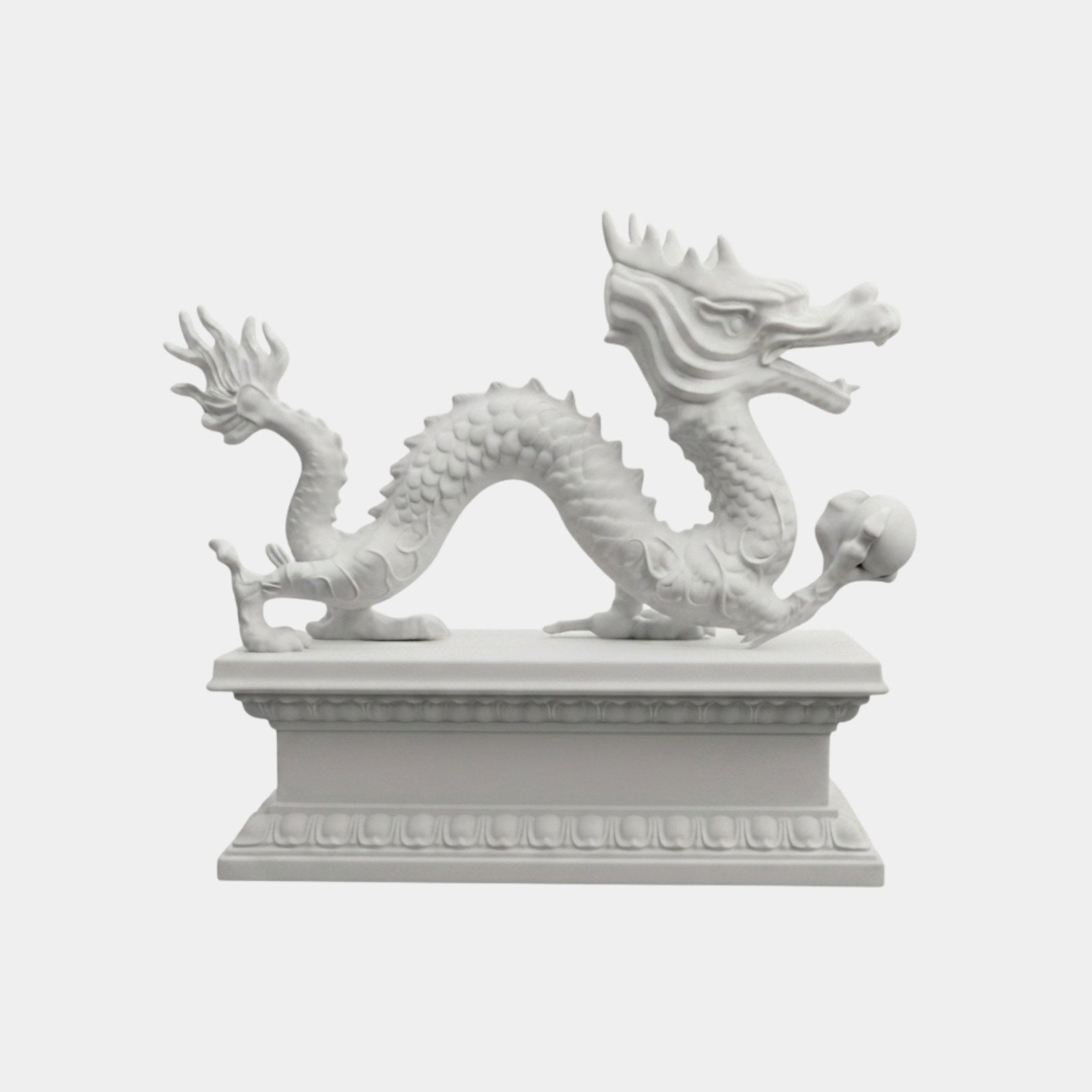 White marble Chinese dragon walking with its back arched and a sphere in one claw