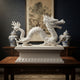 White marble dragon on its moulded plinth in a panelled interior