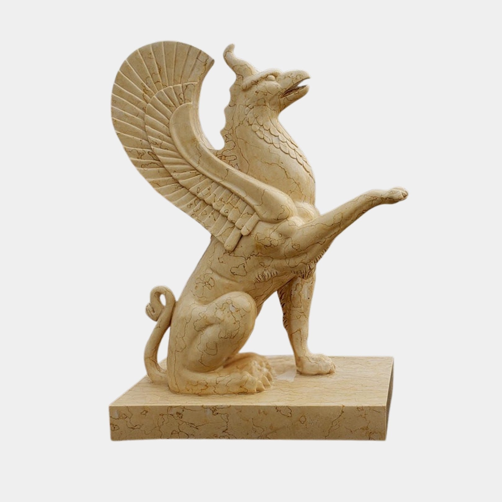 Cream-beige marble griffin seated with an eagle head and one forepaw reaching