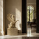 Beige marble griffin shown indoors in a limestone hall