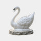 White marble swan at rest on a riven grey-buff marble base