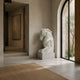 White marble horse head shown indoors in a modern plaster hall