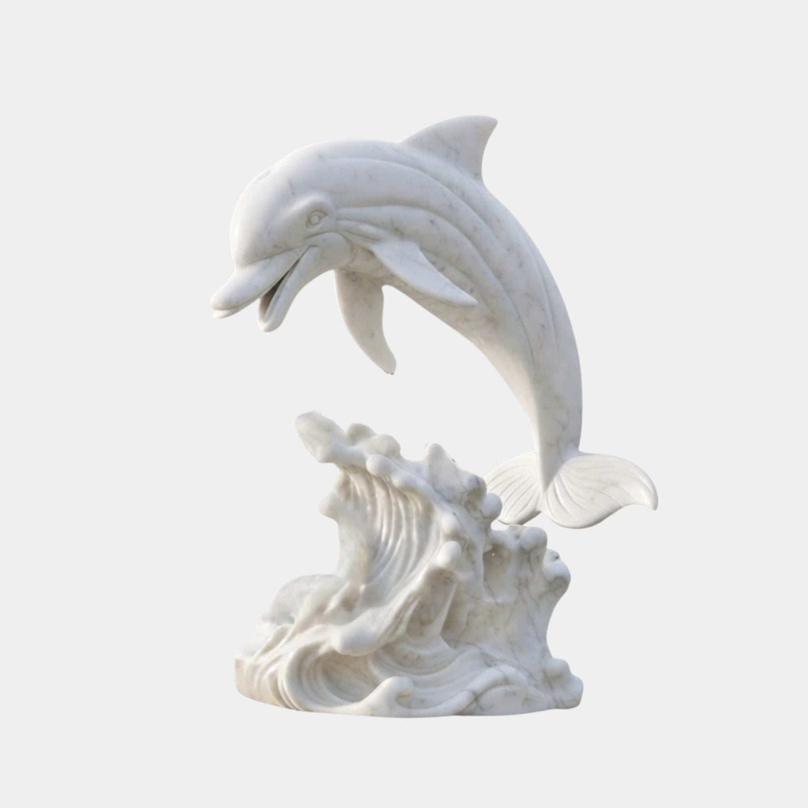 White marble dolphin springing from a carved breaking wave