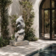 White marble dolphin fountain running, water filling its rough-hewn basin