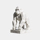 White marble gorilla cut into flat triangular planes, standing on its knuckles