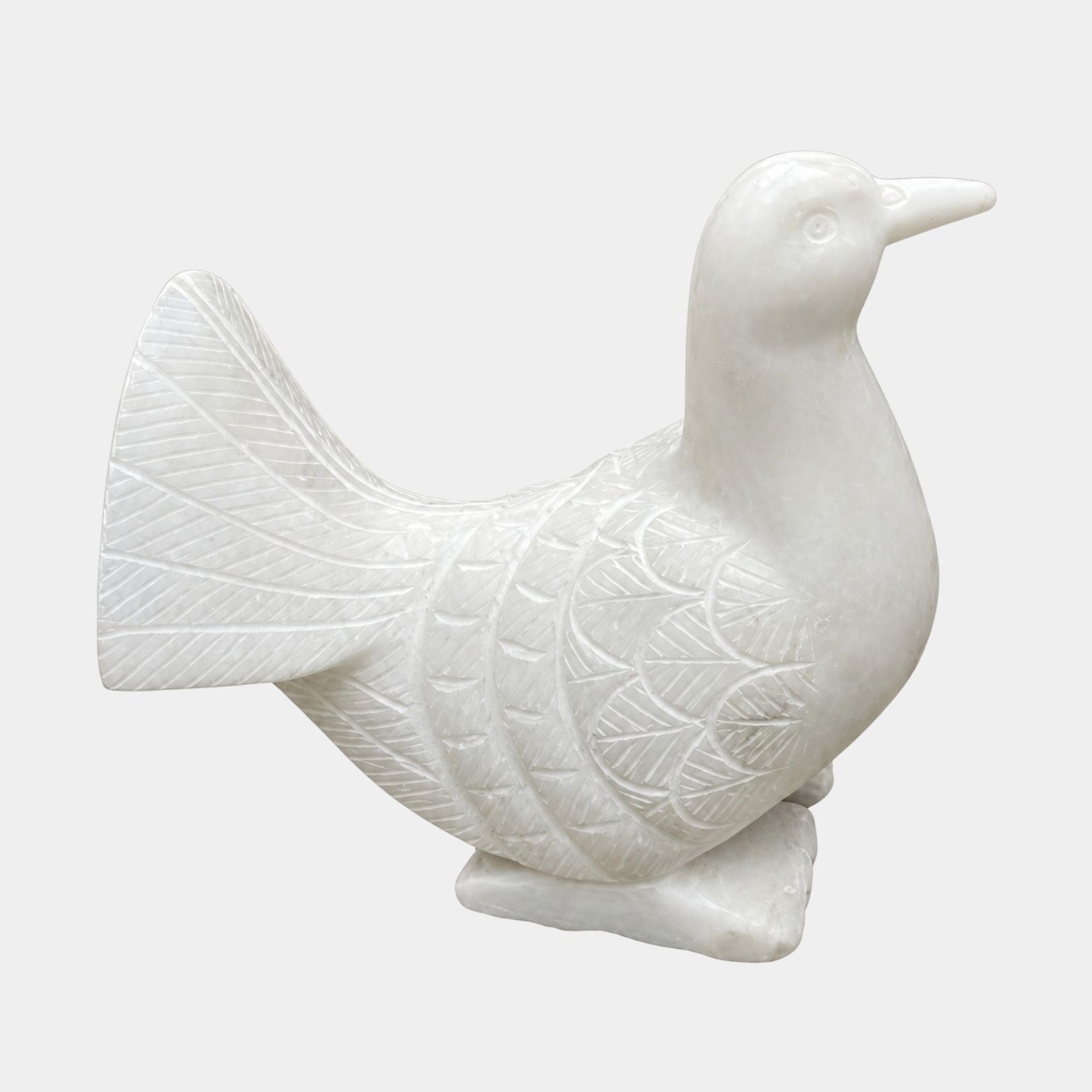Small white marble dove in profile with its tail fanned and lifted