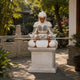 The painted Sun Wukong on its pedestal beside a garden balustrade