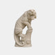 Beige sandstone tiger roaring with a forepaw braced on a carved stump