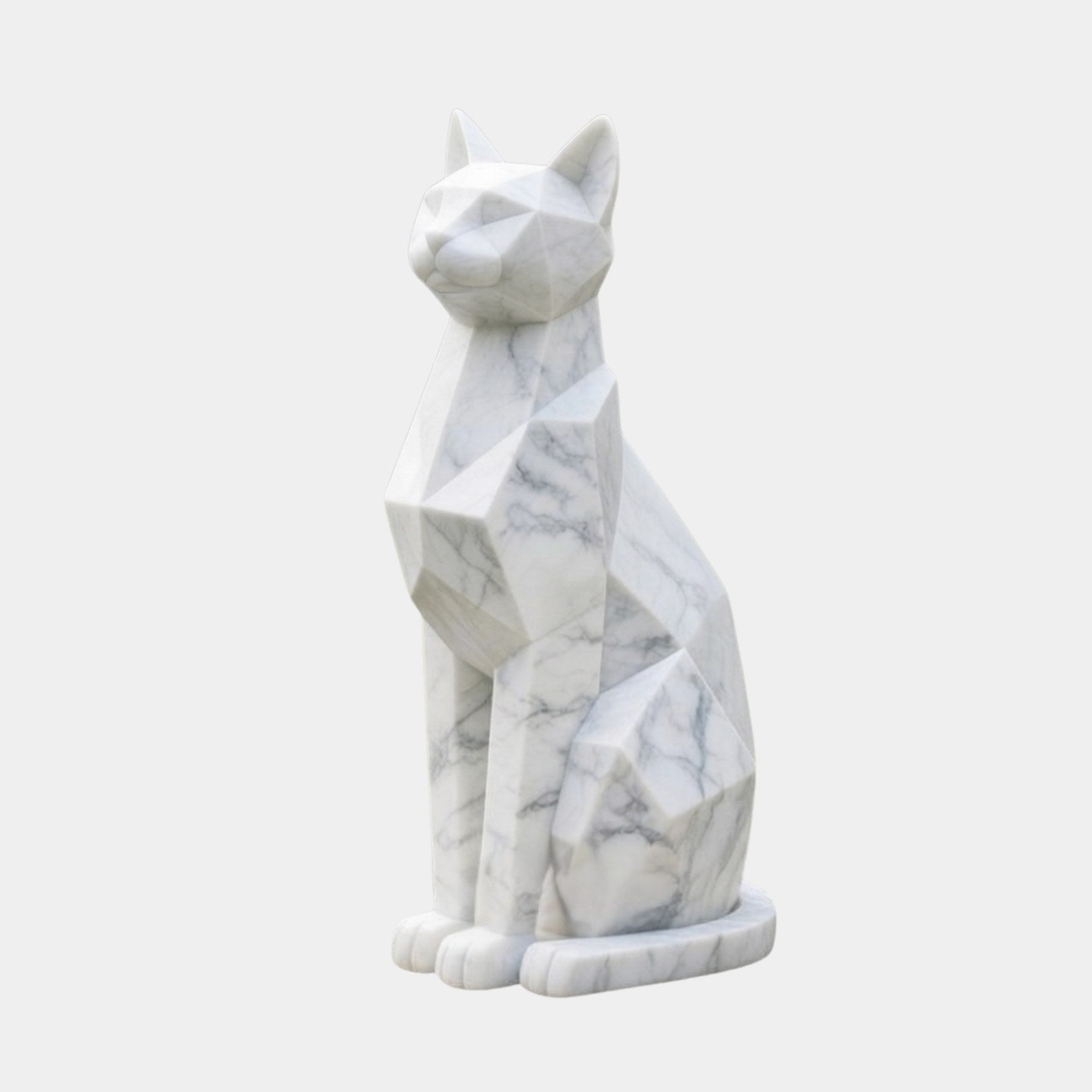 White marble cat sitting upright, cut into flat planes with rounded toes