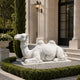 White marble couchant camel on its slab in a gravel bed