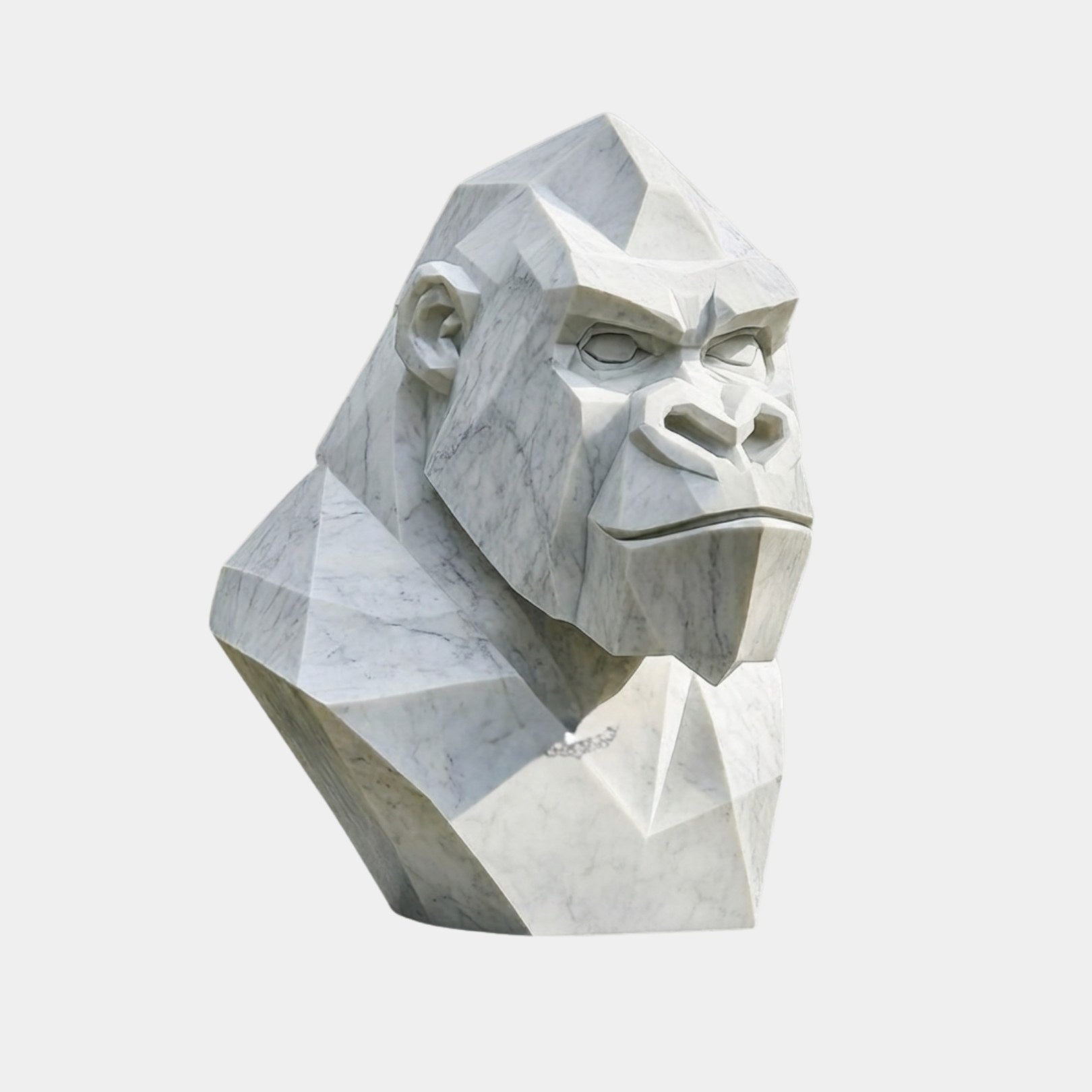 White marble gorilla head cut into flat planes with modelled eyes