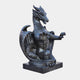 Near-black marble dragon seated with membranous wings and forepaws raised