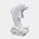White marble dolphin leaping from a bank of tightly scrolled carved waves