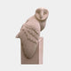 Buff sandstone barn owl perched on a tall square post