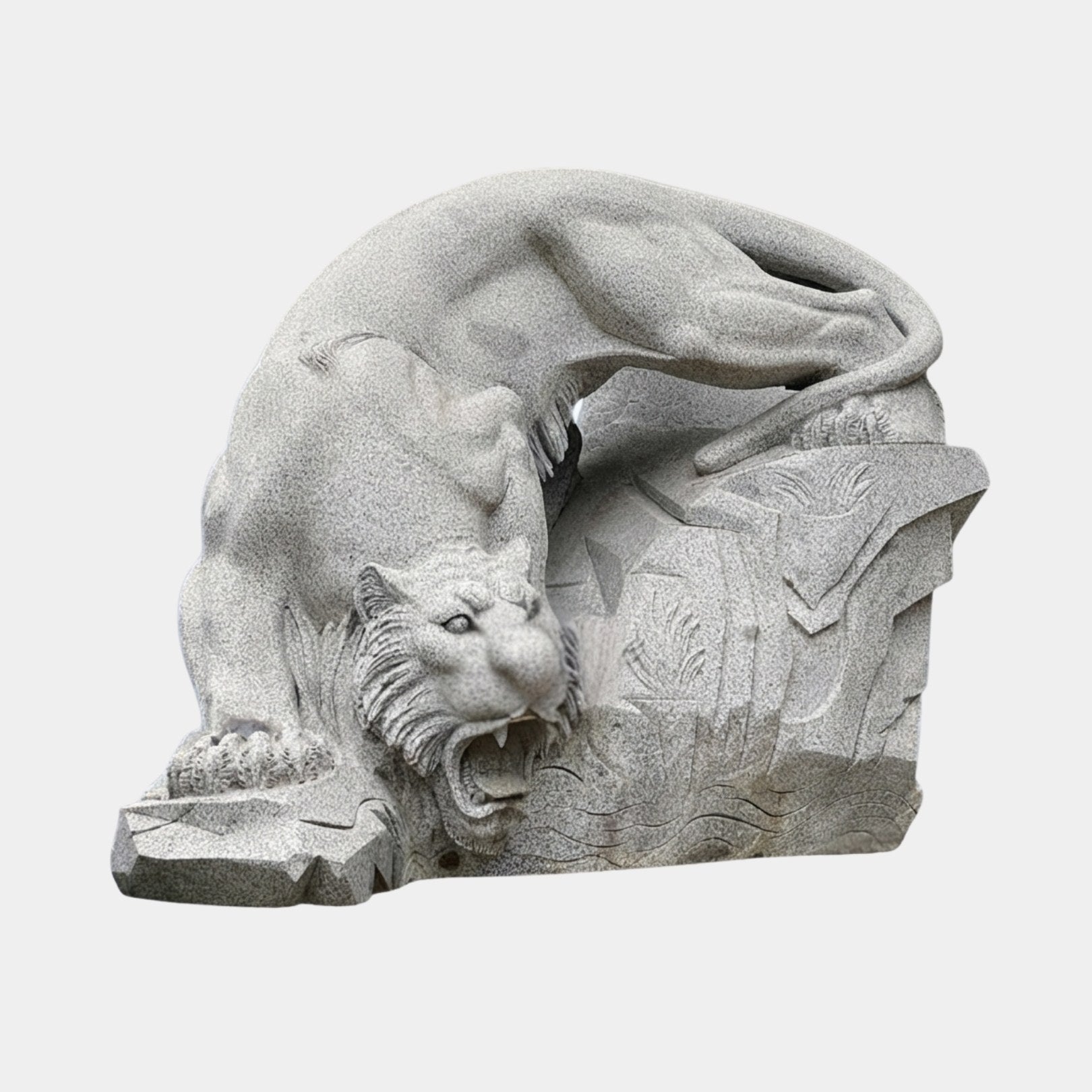Grey granite tiger coming down over a rock with jaws open