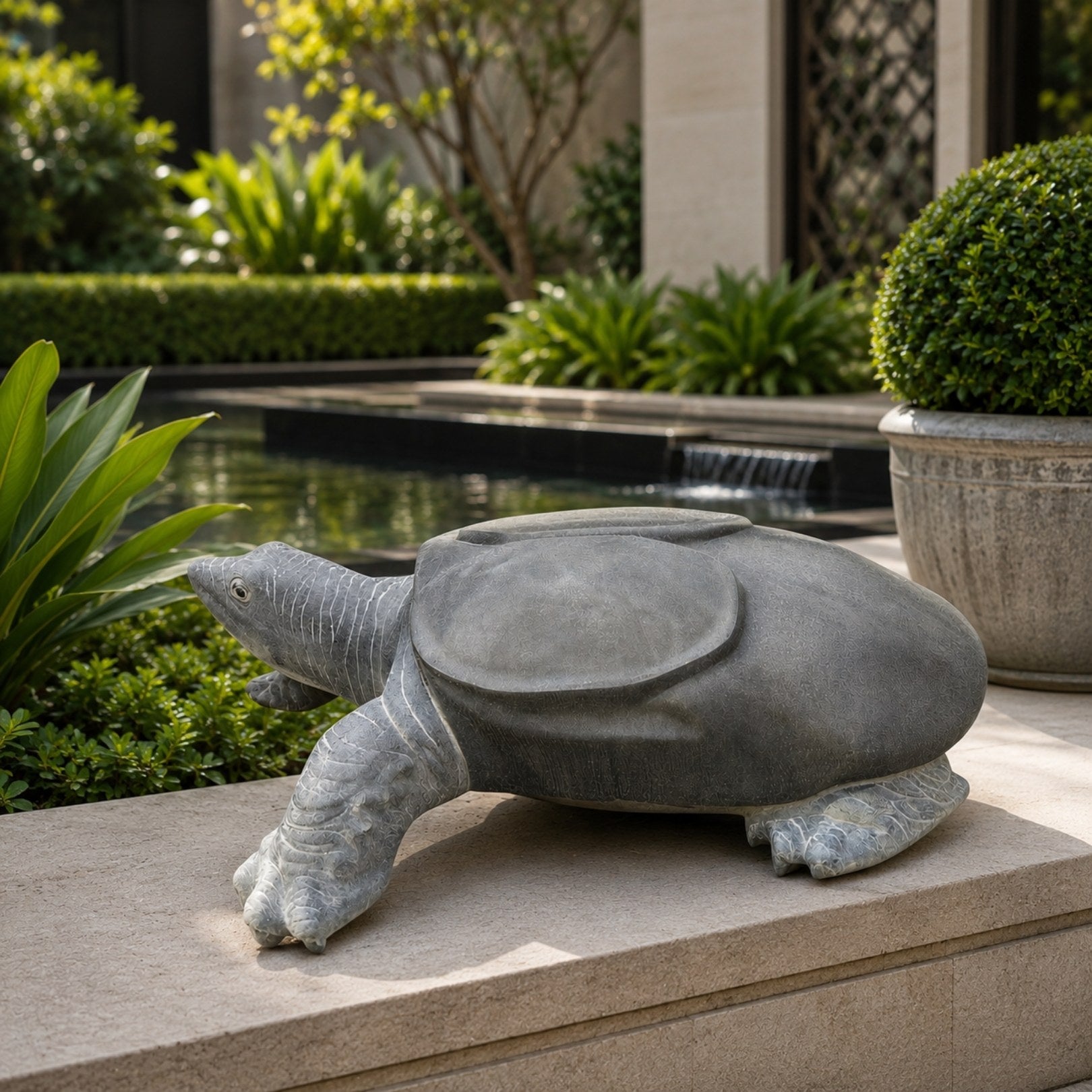 The grey turtle lying on stone coping at the edge of a formal garden pool