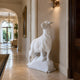 The white marble sheep set against a wall in a panelled hallway