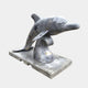 Grey marble dolphin arching clear of the water on a tapered support