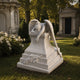 Marble weeping angel memorial shown on a cemetery avenue