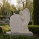 Marble angel and dove headstone shown on a cemetery plot