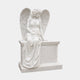 White marble angel seated on a chest-form headstone with carved roses in her lap, 160cm