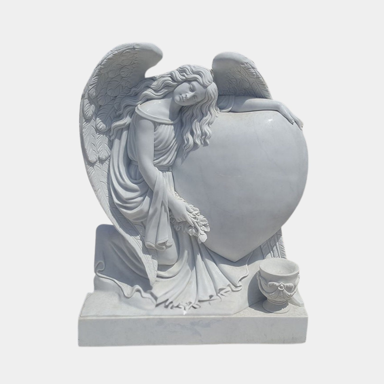 Grey marble angel folded over a large heart tablet with a carved urn beside her, 150cm