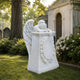 Marble mourning angel pedestal memorial shown on a cemetery plot