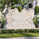 Marble double angel heart headstone shown on a family grave plot