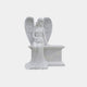White marble angel seated on a bench-form headstone with roses in her lap, 170cm